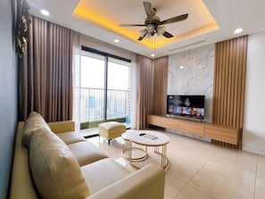 Standard Apartment, Balcony, Lake View | Living area | 40-inch TV with satellite channels - TIL Vinhomes D'capitale Elegance Suites (Hanoi)