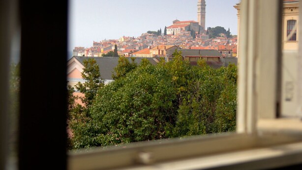 A view of a cityscape with a prominent tower and dense urban buildings. - Scenic Rovinj Apartment With Balcony (Rovinj)