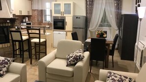 A compact living space with a kitchenette, a dining area, and a seating area with two sofas and a coffee table. - Spacious 3 apartment , villa with WiFi and AC in delightful Dobrota (Dobrota)