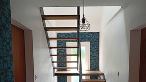 A modern interior with a spiral staircase, patterned walls, and a tiled floor. - Large, cosy house near the town center (Nantes)