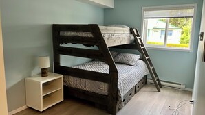 A bunk bed with a ladder, a bedside table with a lamp, and a window with blinds. - Sicamous Townhouse & Boat Slip. Welcome to the lake! (Sicamous)