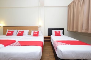 A hotel room with four beds arranged in a row, each with white bedding and red accents. - Hotel O 75 (Temerloh)