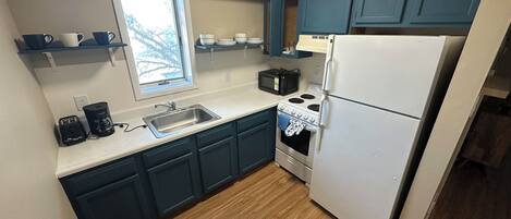 Microwave, stovetop, coffee/tea maker, cookware/dishes/utensils