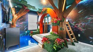 A bedroom with a bed, a dresser, a ladder, and a wall mural. - HOGARTS & AVATAR! MARIO Kart! Pool with Waterpark Close to Disney! (Kissimmee)