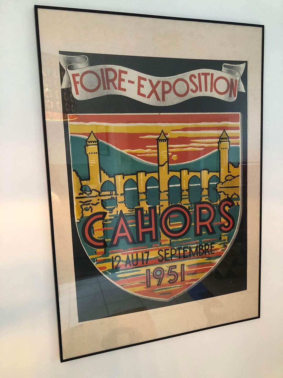 En indrammet plakat med teksten "FOIRE-EXPOSITION" og "CAHORS" samt datoen "12 AUI 1951".