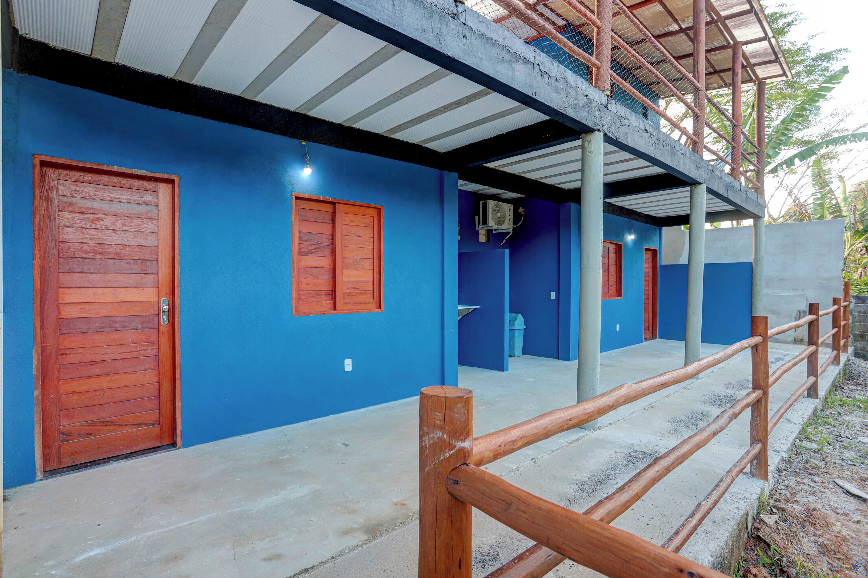 A building with blue walls, wooden doors, and a concrete floor.
