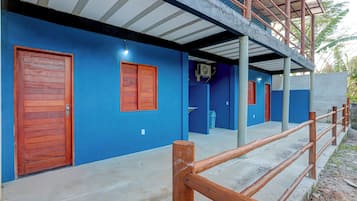 A building with blue walls, wooden doors, and a concrete floor.