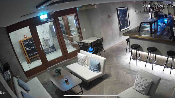 A bar area with a sofa, a small table, and stools. There is a sign for 'Roof-top Happy Hour' and a 'Bar Hecht' sign. - Anita Hostel (Zürich)