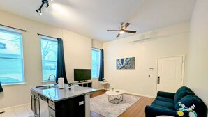 A modern apartment with a kitchen, living area, and a dining space.