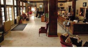 A spacious lobby with a high ceiling, large windows, and a central column. - The Historic Union Hotel (Union)