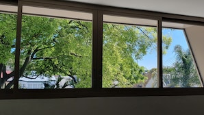 A room with large windows, a ceiling vent, and a door. - 1 BR unit with leafy outlook & dedicated workspace (Glebe)