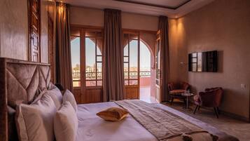 Junior Suite, Garden View | Living area | 50-inch TV with satellite channels, Netflix, streaming services