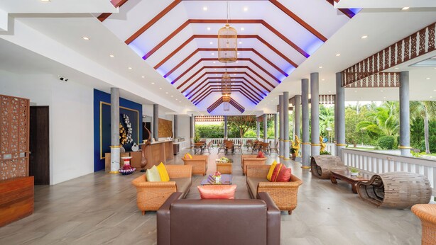 A spacious lobby with a high ceiling, a reception desk, and a seating area with wicker furniture. - Phuket La Siesta Pool Villa And Pool Access (Rawai)