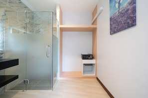 A modern bathroom with a glass shower enclosure, a white vanity, and a small shelf with a microwave. - Phuket La Siesta Pool Villa And Pool Access (Rawai)