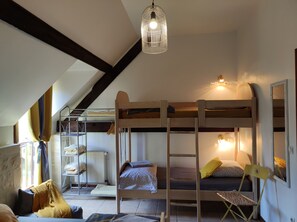 A dormitory room with bunk beds, a ladder, a radiator, and a hanging light fixture. - Magnificent farmhouse on an estate 5 minutes from Caen town center (LOUVIGNY)