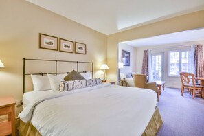 Relax in this inviting room with a large bed, two bedside tables, and a comfortable chair.