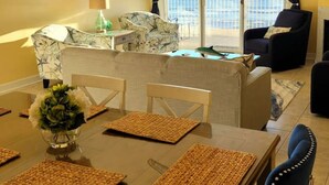 A dining area with a table, chairs, and a ceiling fan. - Oceans Edge 503 on the Boardwalk at 9th St (Ocean City)