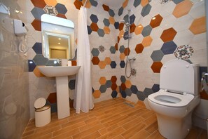 A bathroom with a sink, toilet, shower, and a mirror. - Avenue 30 Hotel (Yerevan)