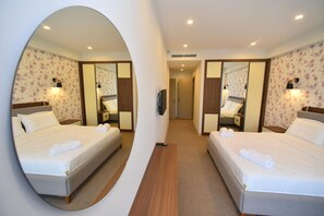 A hotel room with two beds, a mirror, a TV, and a hallway leading to another room. - Avenue 30 Hotel (Yerevan)