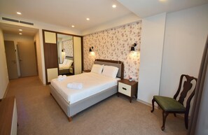 A hotel room with a bed, bedside tables, a chair, and a mirror. - Avenue 30 Hotel (Yerevan)