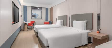 A modern hotel room with two beds, a desk, and a chair.