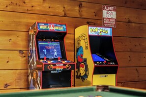Two arcade machines, one labeled 'Midway Mortal Kombat' and the other 'Pac-Man,' against a wooden wall backdrop. - Stunning 5 Acre Lake Cabin, Community Pool - Easy Drive (Sevierville)
