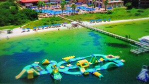 A resort with a pool area, a beach, and a water park.