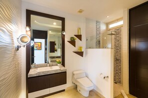 A modern bathroom with a vanity, toilet, and shower area. - Signature by Pinnacle (Puerto Vallarta)