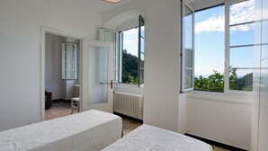 A bedroom with two beds, a window, a radiator, and a door leading to another room. - 2 bedroom gorgeous apartment in Semorile (Semorile)