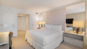 A modern hotel room with a large bed, bedside tables with lamps, a flat-screen TV, and a large mirror. - 1Hotel South Beach  OceanView, Pool, Gym, (Miami Beach)