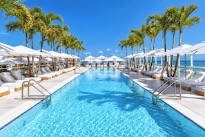 Resort-style oceanfront pool with palm-lined loungers and sunny tropical views - 1Hotel South Beach  OceanView, Pool, Gym, (Miami Beach)