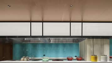 A modern kitchen with a teal backsplash, stainless steel appliances, and a neutral color palette.