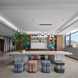 A modern kitchen with a central island, pendant lighting, and a large window offering a city view. - Hilton Garden Inn Beijing Yizhuang (Beijing)