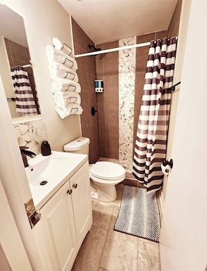 Shower, hair dryer, towels, soap