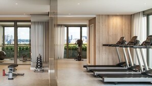 A modern gym with treadmills, weight machines, and a mirror. - Studio exclusivo Brooklin 230m do metrô (São Paulo)
