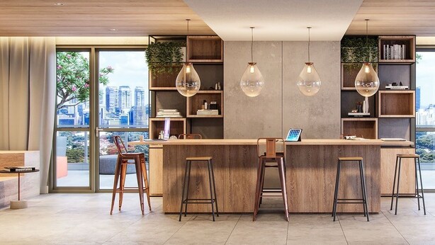 A modern kitchen with a central island, bar stools, pendant lighting, and large windows offering city views. - Studio exclusivo Brooklin 230m do metrô (São Paulo)