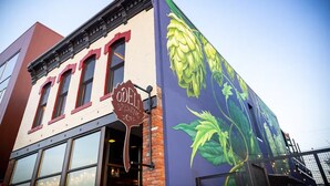 A building with a mural of hops on the side, a sign for Odell Brewing Co., and large windows. - Bright and Modern Studio Guesthouse - near RiNo! (Denver)