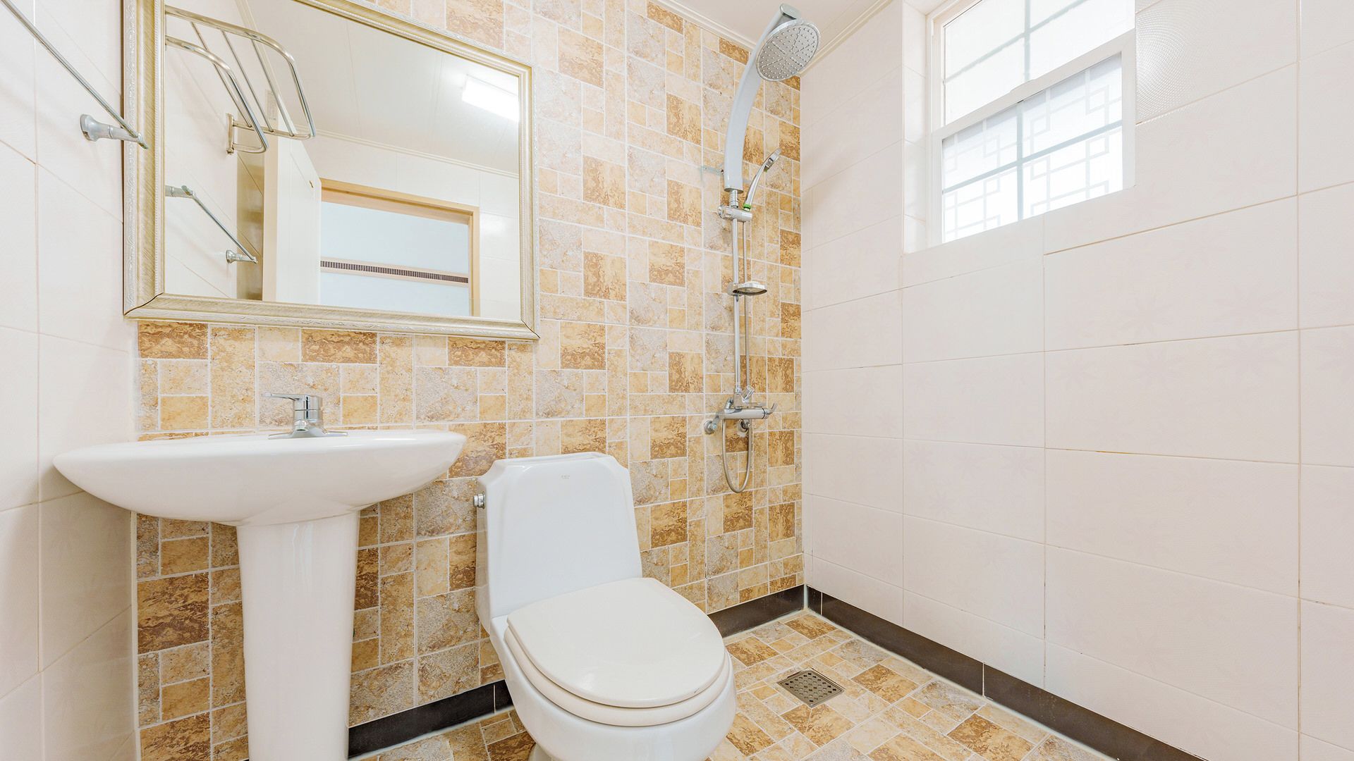 A bathroom with a white sink, toilet, and shower.