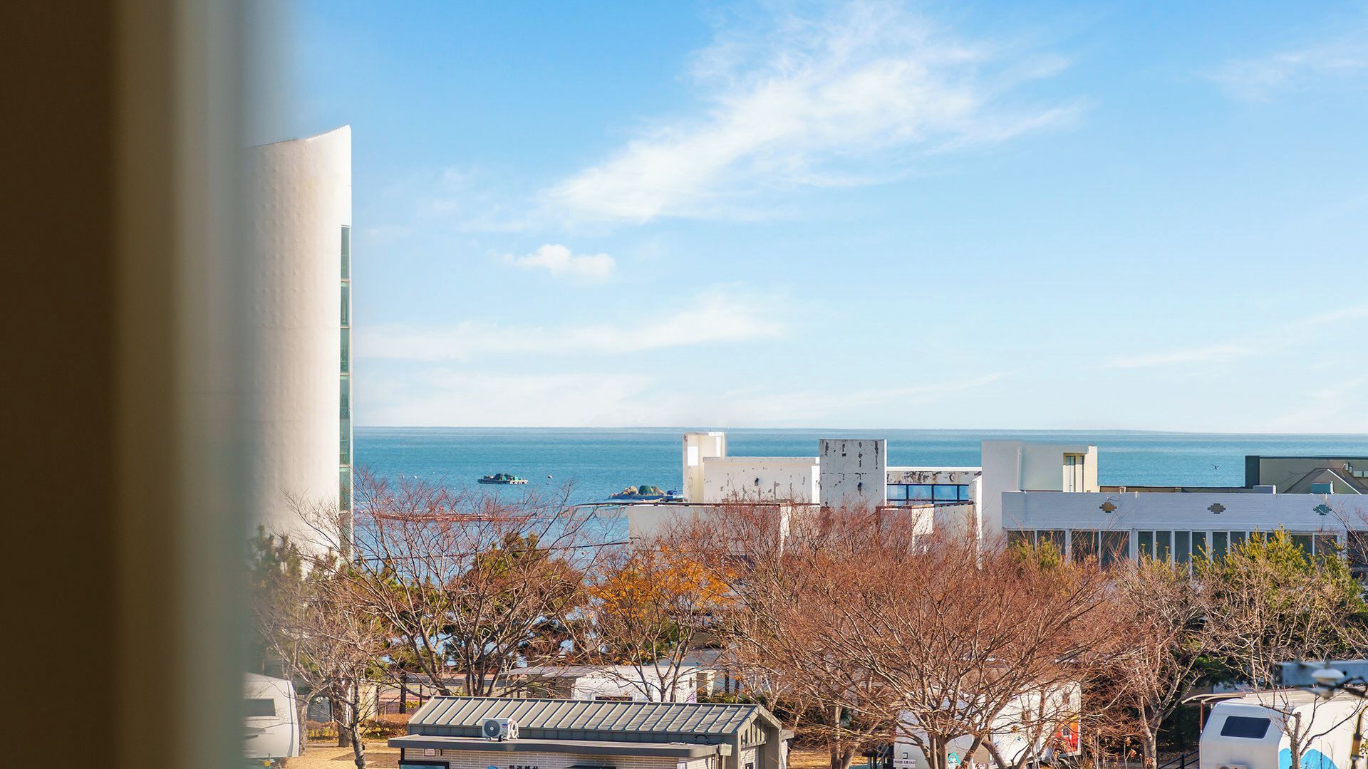 A coastal view with buildings and a clear sky.