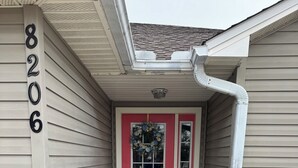 A house with a red door, a mailbox, and a number 8206 on the wall. - Charming retreat across from Beach access 18 and steps to local attractions.  (Panama City Beach)