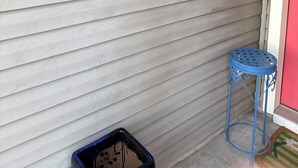 A garage door with a 'PARTY TIME!' sign featuring flamingos and a drink. - Charming retreat across from Beach access 18 and steps to local attractions.  (Panama City Beach)