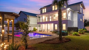 A two-story house with a swimming pool, outdoor seating, and a well-lit patio area. - 🌅 Saltwater Sunsets | Private Pool & Close to Beach | Dog Friendly* | FREE Excursions ☀️ (Destin)