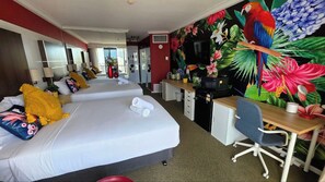 A hotel room with two beds, a desk, and a vibrant tropical mural. - Cozy Ocean View Hotel Room丨Sleeps 4丨2 Double-Bed (Surfers Paradise)