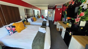 A hotel room with two beds, a desk, a television, and a minibar. - Cozy Ocean View Hotel Room丨Sleeps 4丨2 Double-Bed (Surfers Paradise)