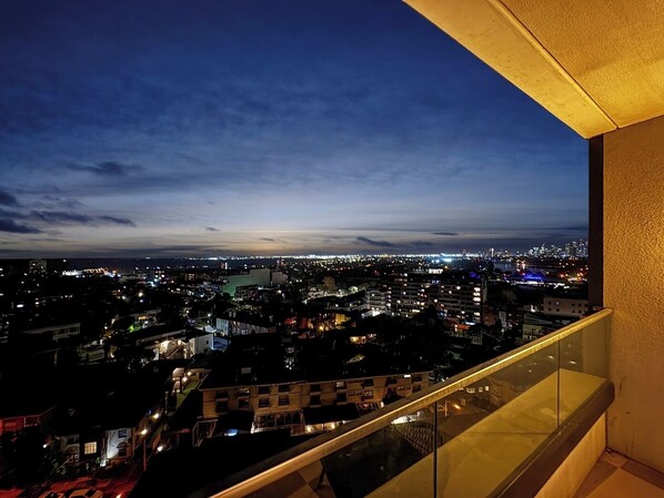 Enjoy a panoramic view of the city from this balcony, overlooking the vibrant urban landscape.