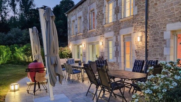 An outdoor patio with a stone building, a grill, and outdoor furniture. - 7 bedroom beautiful home in Flaignes-Havys (Flaignes-Havys)