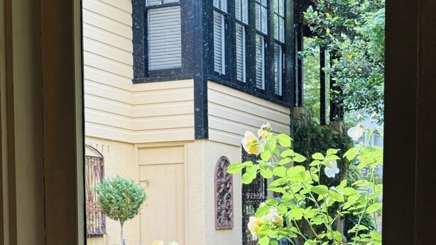 A window with a view of a house and garden. - Leura's Magical Manderley - Studio Room (Leura)