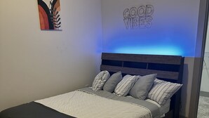 A neatly made bed with a headboard, a black throw blanket, and striped pillows. - Cozy 1-bedroom apartment in beautiful downtown Atlanta with amazing view  (Atlanta)