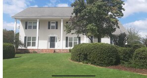 Classic two-story building with a central entrance and well-manicured grounds.