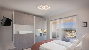 A modern bedroom with a large bed, a TV mounted on the wall, and a view of the city through the window. - Perla Garda Lake Apartment With Pool (Peschiera del Garda)